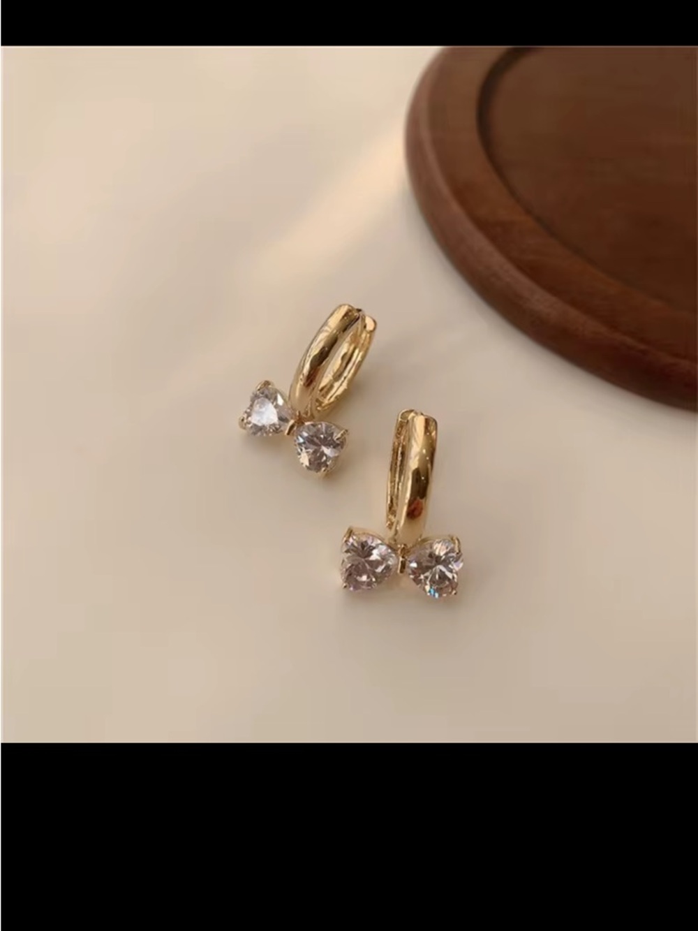 Gold Huggie Earrings with Clear Crystal Bow Accents